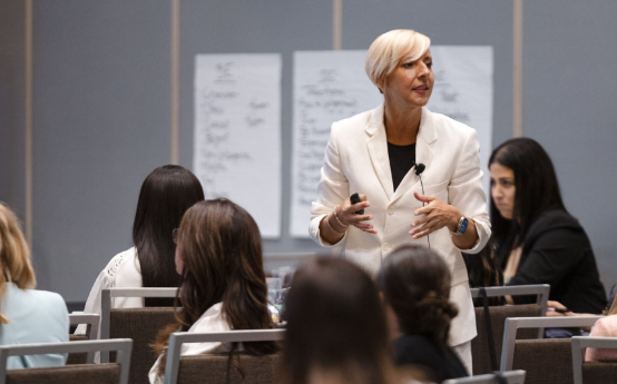 Woman presenting to a group in a conference room